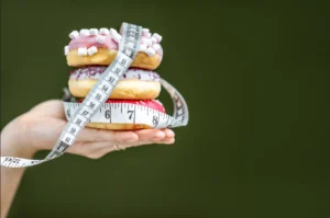 Assorted donuts on a plate showcasing different flavors and toppings, highlighting the variety and appeal of this popular treat while considering their caloric content.