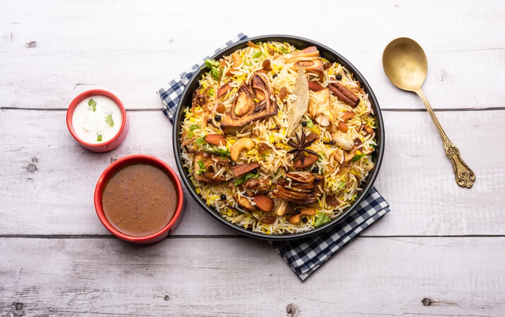 Finished chicken fried rice served in a bowl, garnished with green onions and sesame seeds.