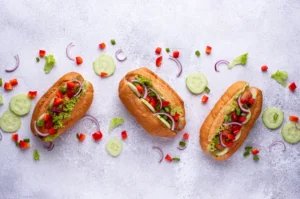 Delicious air fryer hot dogs with a golden, crispy exterior and juicy interior, served with a side of toasted buns and a variety of toppings.