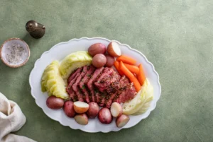 Crock pot filled with savory corned beef and vibrant vegetables, showcasing the rich, tender meal prepared for a comforting family dinner.