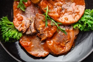 Slow cooker filled with corned beef and vegetables, showcasing the debate on whether to cover the meat with water for optimal cooking.