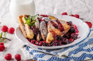 Delicious dairy-free French toast served with fresh berries and maple syrup on a rustic wooden table, showcasing a milk-free breakfast option.