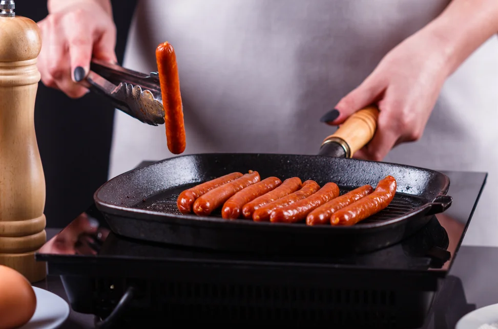 Delicious stove-cooked hot dogs in a skillet with golden-brown perfection