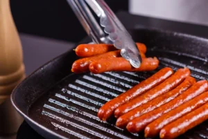 Delicious stove-cooked hot dogs in a skillet with golden-brown perfection