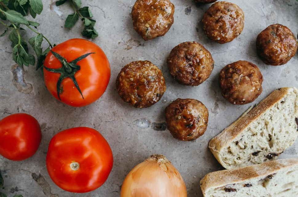 Juicy sweet and sour meatballs coated in a glossy sauce, served over a bed of steamed rice.