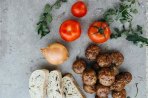 Juicy sweet and sour meatballs coated in a glossy sauce, served over a bed of steamed rice.