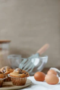 Homemade pumpkin chocolate chip muffins cooling on a wire rack, ready to be enjoyed with a cup of coffee.